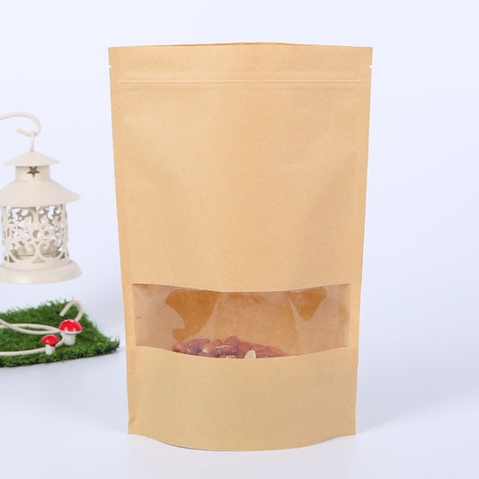 Brown kraft stand-up zipper pouch with frosted window, showing round red candies inside