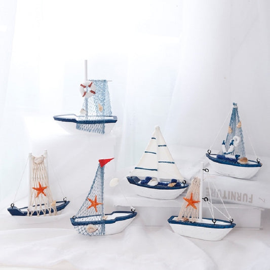 Set of canvas sailboat decorations with blue hulls, red flags, starfish accents, net sails