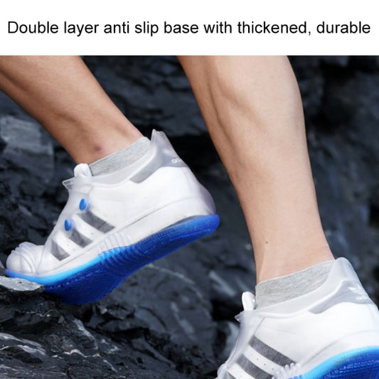 Low-top waterproof rain shoe covers, white with blue non-slip sole on wet pavement