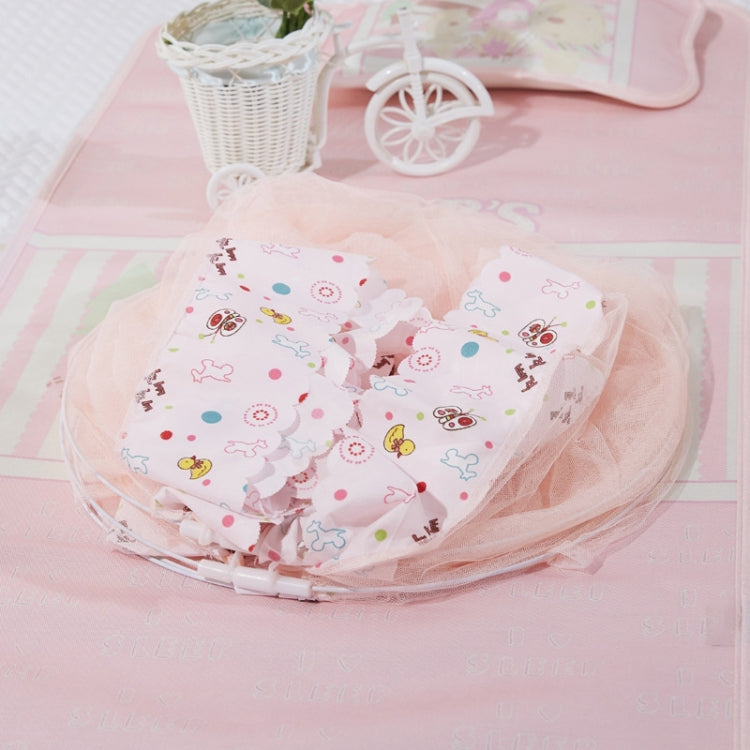 Children’s baby dome mosquito net on a floor with pastel patterned mat and soft accessories