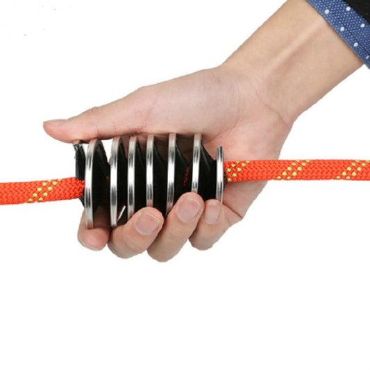 Rope cleaning brush with metal spring bristles and black base, held for use