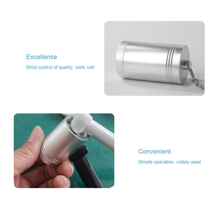 Silver magnetic tag remover cylinder with chain, held in hand