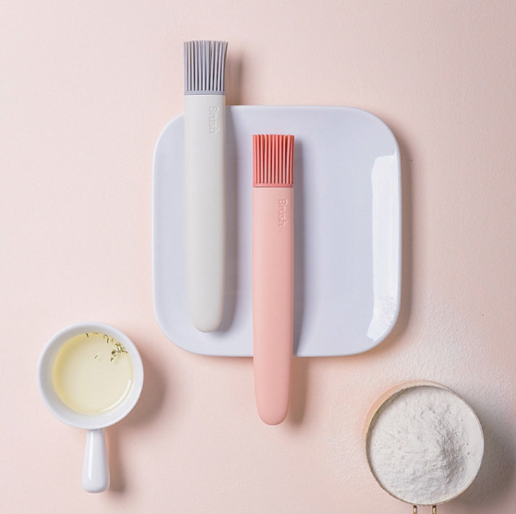Silicone oil brush set with pink and gray bristle heads on a holder