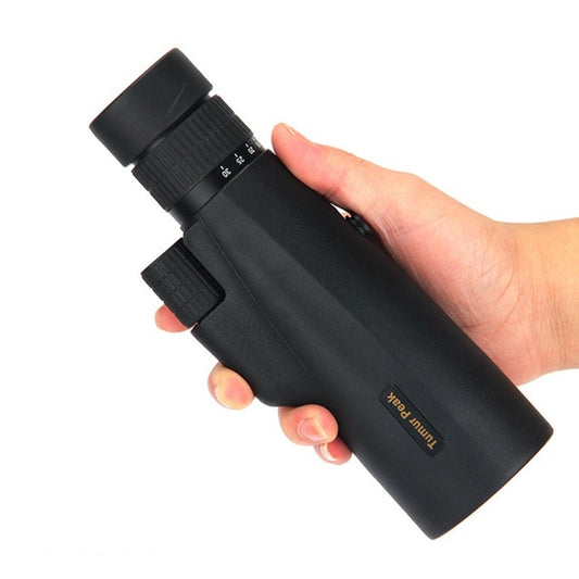 Black night vision monocular telescope held in hand with textured focus ring