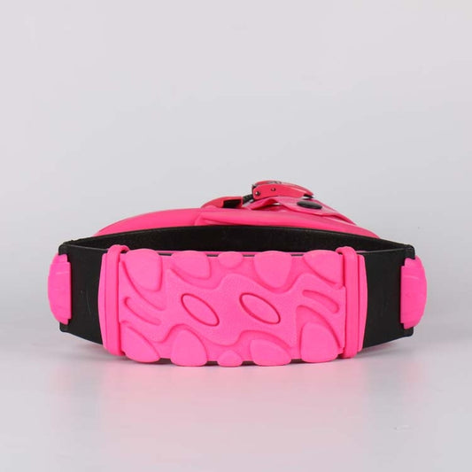 Pink and black jumping shoe sole with textured tread and adjustable strap