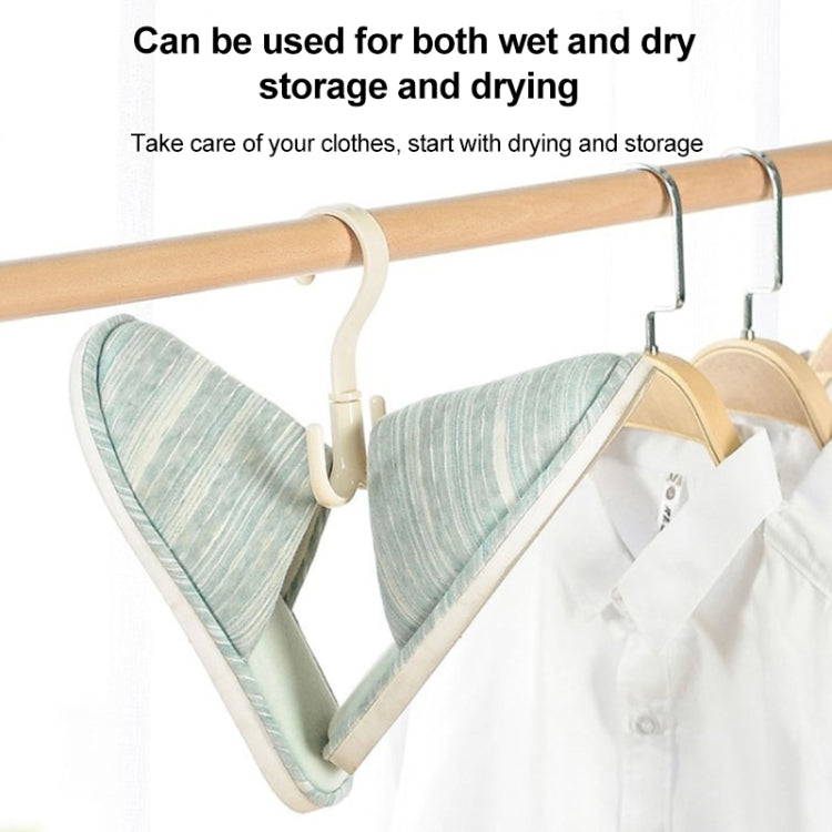 Rotatable belt hook on light wood bar next to metal hangers, holding clothing