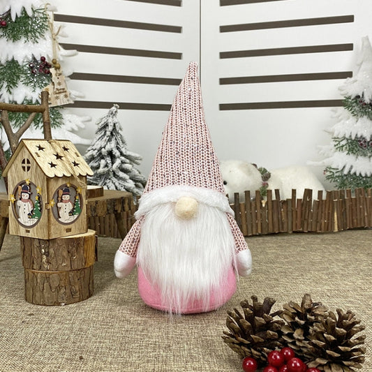 Pink knitted gnome decoration with fluffy white beard and beige nose ball