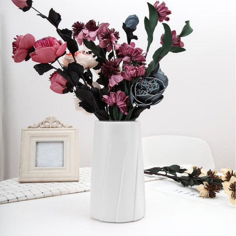 Milk white plastic table vase with fluted sides, filled with faux flowers
