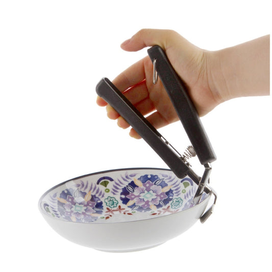 Black bowl picker clamp in hand holding a patterned bowl by the rim