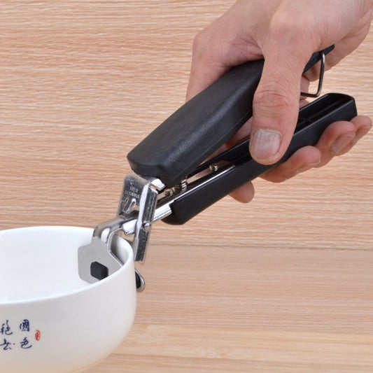 Black bowl picker clamp with spring grip handle, held over a bowl rim