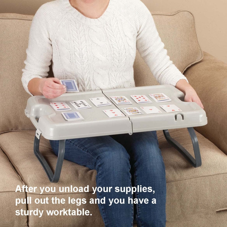 Folding lap table with extended legs, light gray top holding a deck of cards