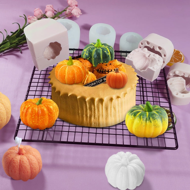 Silicone pumpkin cake mold with 3D jack-o-lantern cavities, white mold blocks