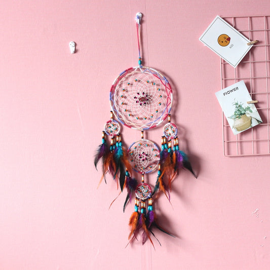 Colorful dream catcher wall hanging with woven rings, dangling feathers, and bead accents