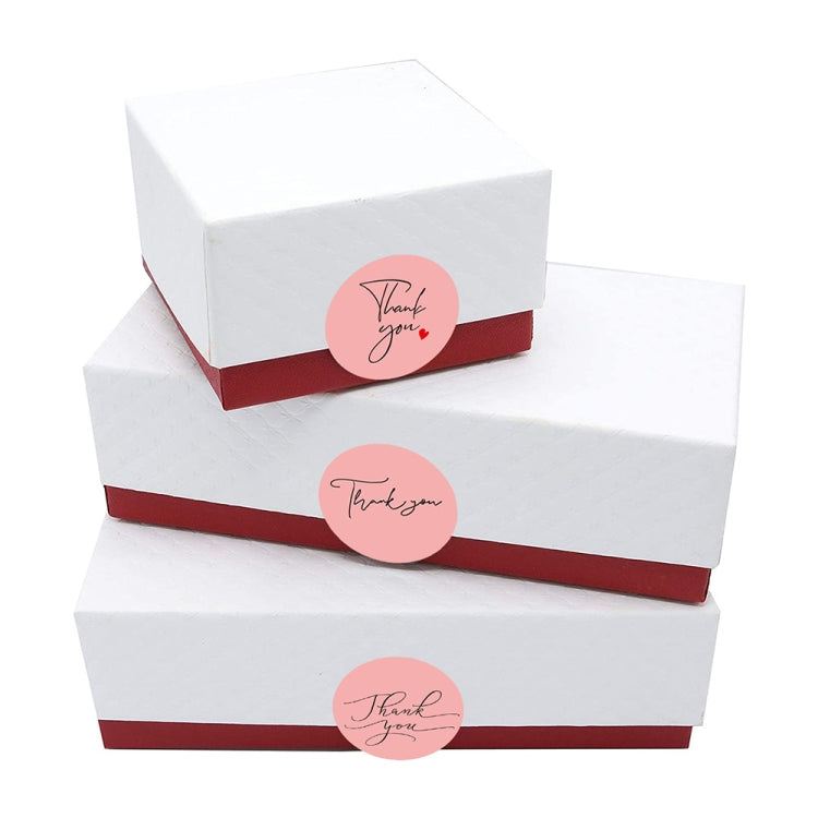 Thank you round baking stickers on stacked gift boxes with red bands