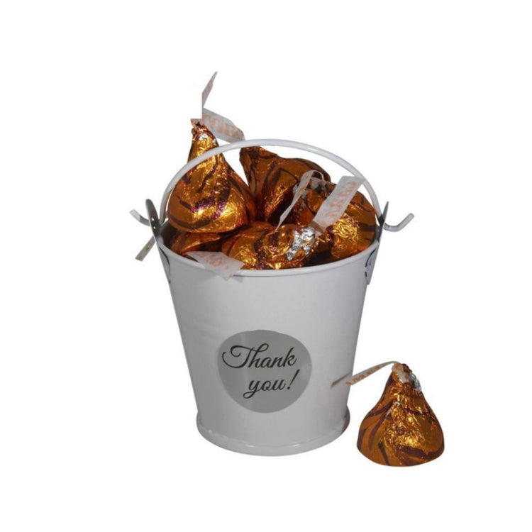 Thank-you sticker bucket with wrapped chocolates and gold foil candies
