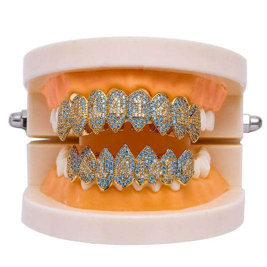 Gold and blue rhinestone teeth grill braces on white retainer frame