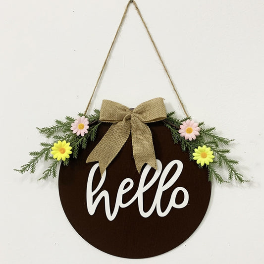 Brown hanging door wreath sign with “hello,” burlap bow, and faux flowers