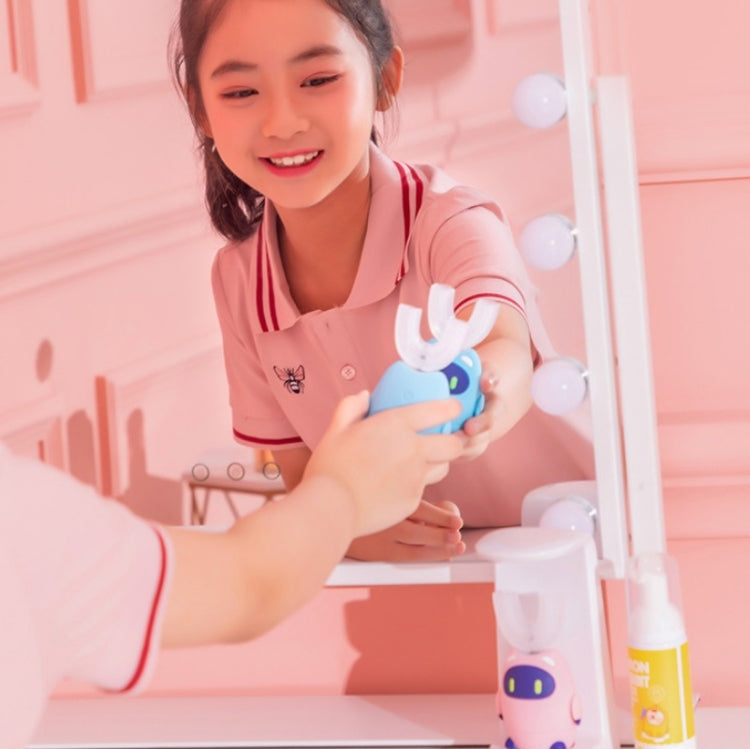 Blue electric toothbrush held by child with white U-shaped bristle head