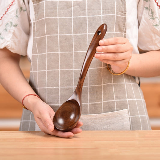 Wooden serving ladle spoon with deep oval bowl and long handle, dark teak brown
