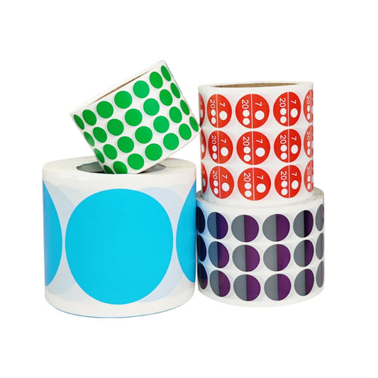 Set of round paper sticker rolls with green, blue, purple, and red circular prints