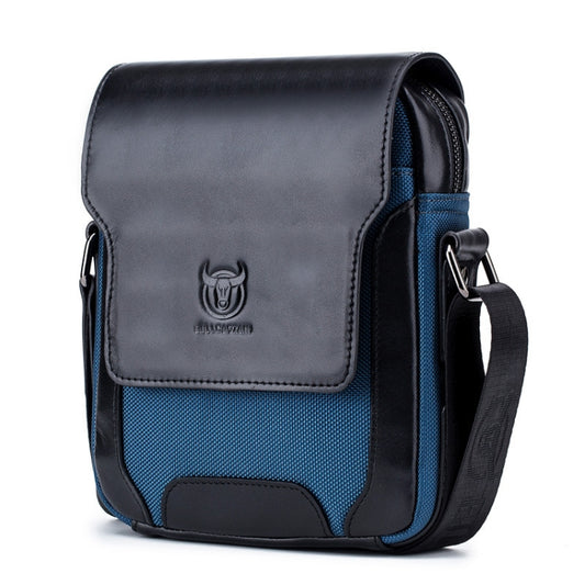 Leather diagonal shoulder bag with flap, dark exterior, blue textured panel, and front logo
