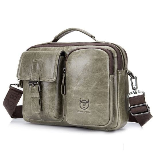 Beige leather messenger bag with front flap pockets, top handle, and adjustable crossbody strap