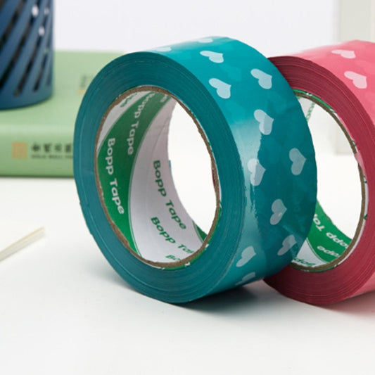 Heart-pattern BOPP sealing tape rolls in teal and pink with white heart icons