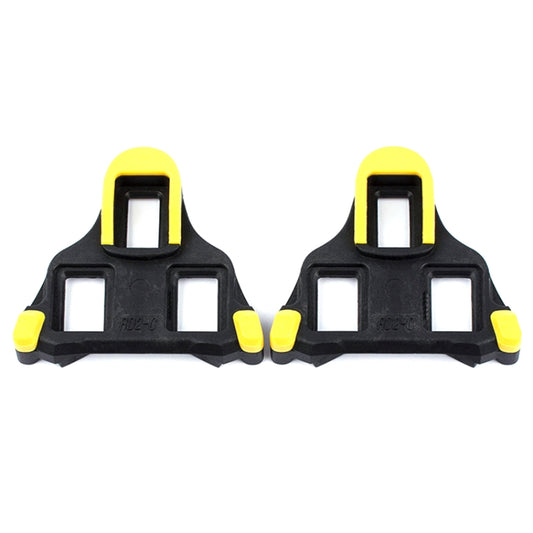Set of yellow road bike shoe lock cleats with four-bolt mounting