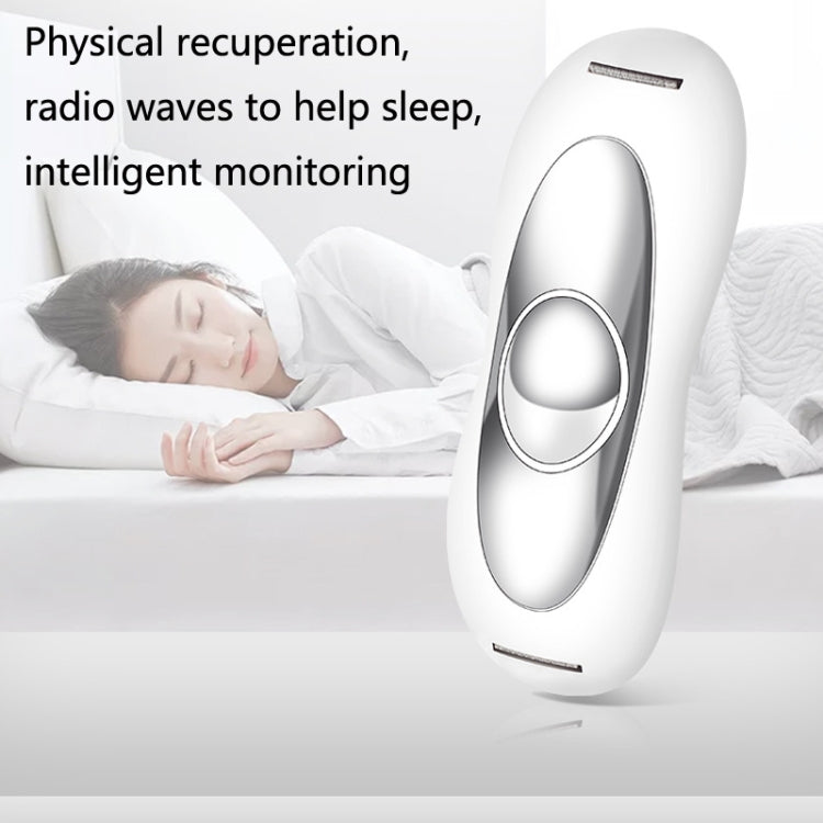 White sleep aid device beside bed pillow with oval sensor and power strip