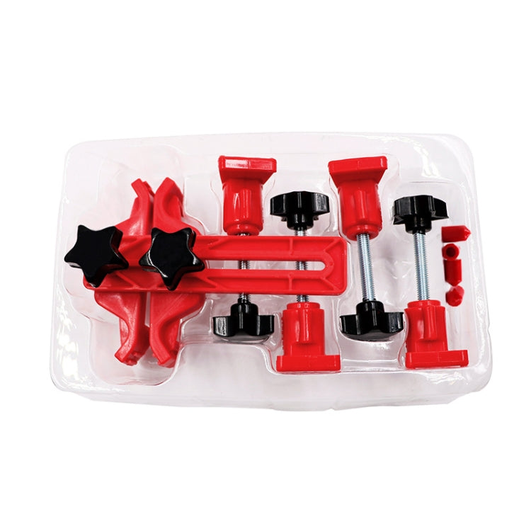 Red cam locking tool parts in a clear plastic tray with black star pieces