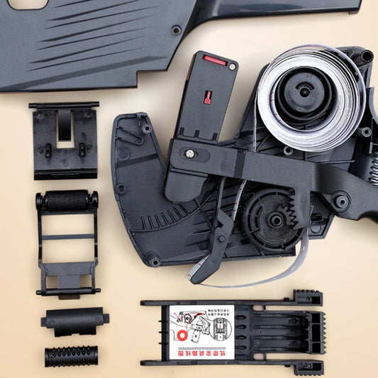 Handheld label printer components laid out, including roller and ink wheels