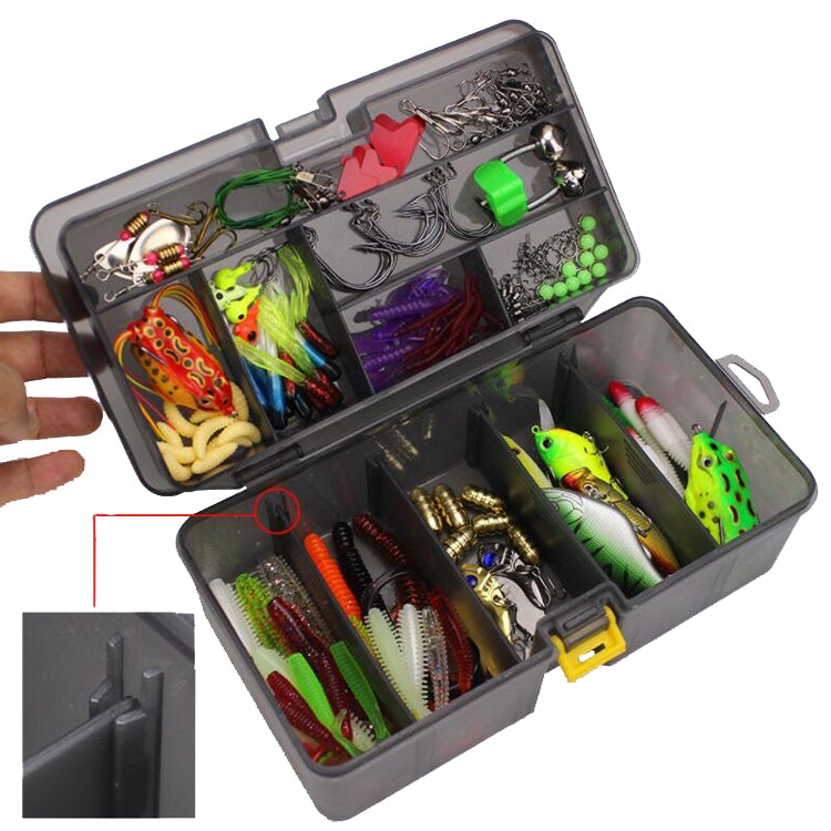 Fishing lure accessories set in open tackle box held in hand with colorful lures in trays