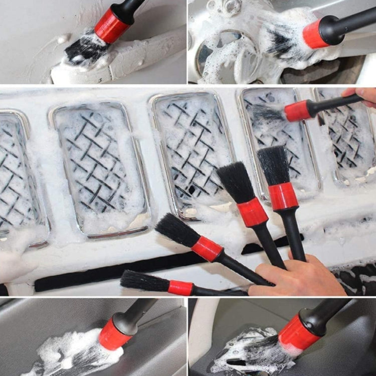 Car cleaning brush heads with red collars and foam tips, shown in soapy water