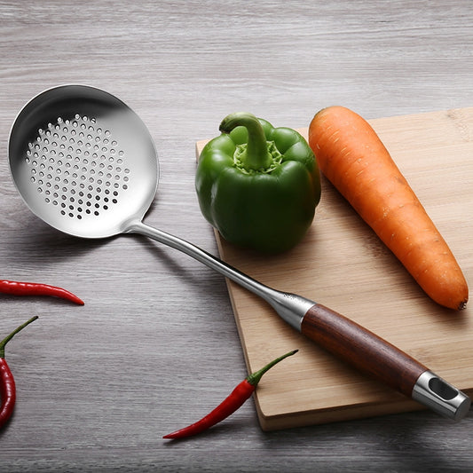 Stainless steel slotted spoon with wooden handle, round bowl with perforations.