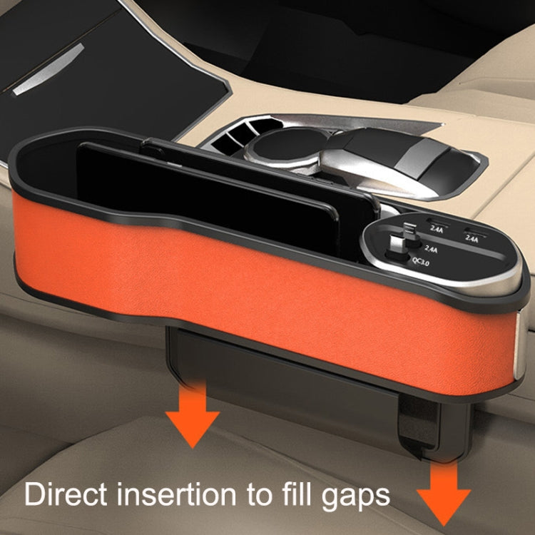 Car seat slot storage box installed with open tray and charging ports visible