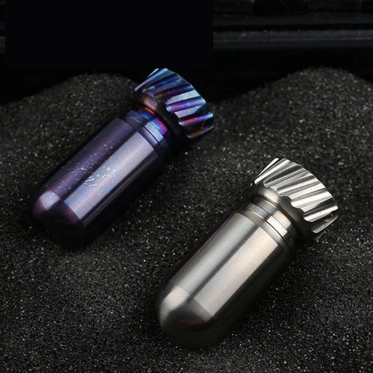 Titanium mini pill jars with ribbed caps in brushed silver and blue finishes.
