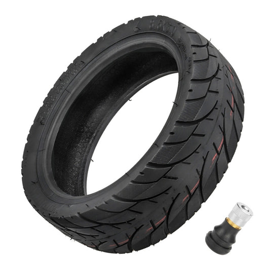 Black 8.5-inch tubeless scooter tire with tread pattern and included valve stem