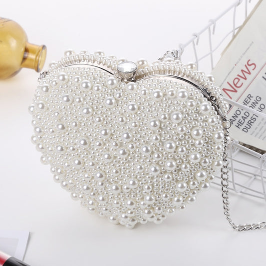 Heart-shaped pearl clutch with beaded surface, silver frame and top clasp