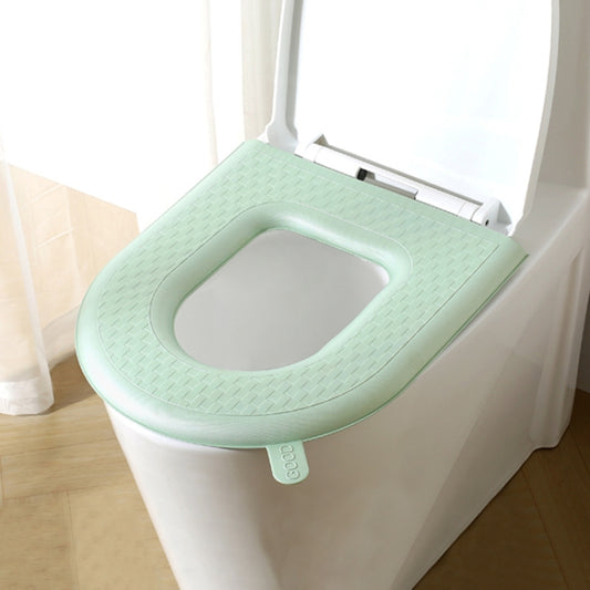 Green toilet seat cover with oval opening and textured surface