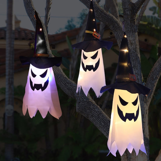 LED hanging wizard hat light with jack-o'-lantern face, warm white glow.