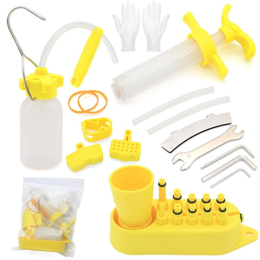 Mountain bike oil filling tool kit with yellow funnel, hoses, nozzles, and oil bottle