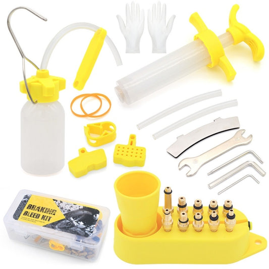 Mountain bike oil filling tool kit with yellow funnel, clear tubes, nozzles, and oil bottle