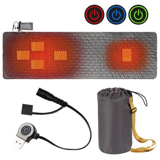 Gray and orange portable heated sleeping pad with glowing heat zones and power cable