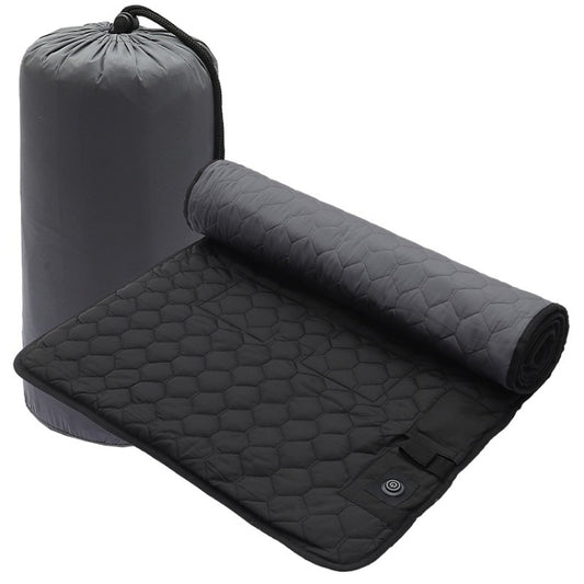 Black and gray hex-quilt heating sleeping bag pad, rolled with carry strap
