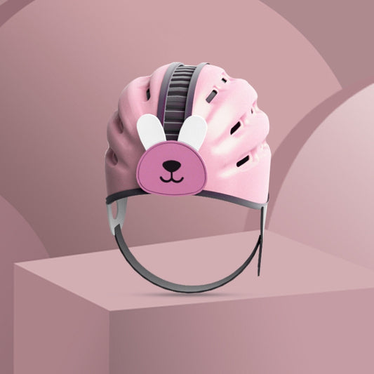 Rabbit-faced baby safety helmet, pink shell with black chin strap and purple ear badge