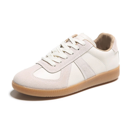 Beige low-top lace-up sneakers with cushioned collar and gum sole