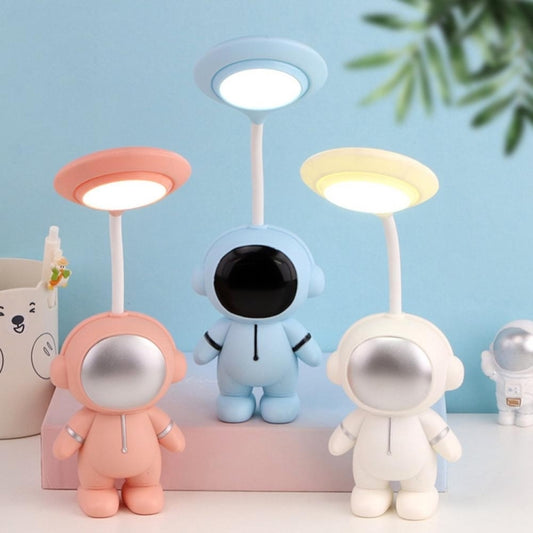 Three astronaut LED reading lamps in pink, blue, and white with round lit heads