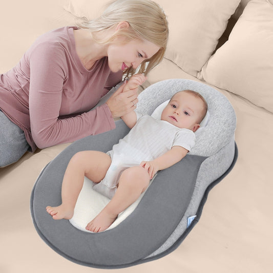 Gray lying breastfeeding baby pillow with contoured supportive cradle