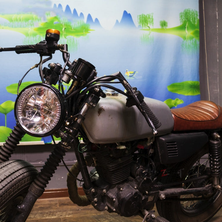Motorcycle LED headlight with angel ring mounted on a black retro bike, clear lens