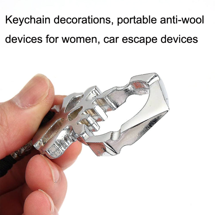 Handheld silver skull self-defense keychain with black cord and metal ring
